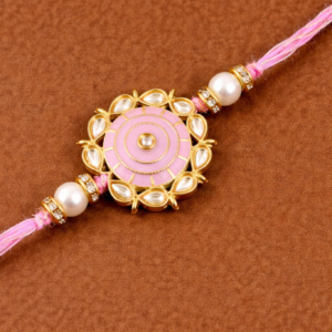 Elegant green rakhi with gold floral medallion, pearl beads, and stone detailing on braided green thread.